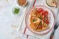 Stack of gluten free buckwheat flour crepes pancakes with cherry tomatoes and arugula microgreens on white plate, homemade healthy Royalty Free Stock Photo