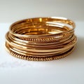 A stack of gold bangles with a white background Royalty Free Stock Photo