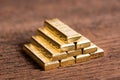 Stack of gold bar on wood background Royalty Free Stock Photo