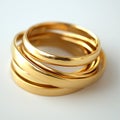A stack of gold bracelets with a white background Royalty Free Stock Photo