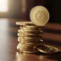 A stack of gold coins is neatly arranged on a wooden surface Royalty Free Stock Photo