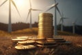 Stack of gold coins with windmills on background. Return on investment on renewable clean energy.