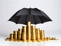 A stack of gold-colored coins protected by an umbrella Royalty Free Stock Photo