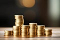 stack of golden coins increasing in height on a simple desk