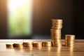 stack of golden coins increasing in height on a simple desk