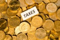 Taxes sign on golden coins Royalty Free Stock Photo
