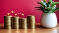 A stack of golden coins, steadily increasing in size, is placed next to a green plant, signifying prosperity and Royalty Free Stock Photo