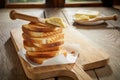 Stack of golden crispy toast with butter spreader