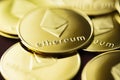 Stack of golden ether coins or Ethereum coins close up depicting cryptocurrency and digital money