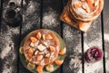 Stack of golden pancakes with bananas and oranges on wooden board covered with caster sugar top view Heap of american pancakes Royalty Free Stock Photo