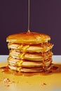 stack of golden pancakes with syrup drizzle