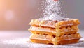 A stack of golden waffles generously dusted with falling powdered sugar. Appetizing breakfast scene Royalty Free Stock Photo