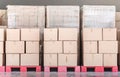 Stack of goods carton boxes on red pallet at logistics warehouse