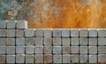 stack gray concrete blocks is arranged in grid-like pattern, with vibrant orange and red background. Royalty Free Stock Photo