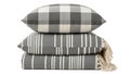 Stack of gray and white decorative pillows and throw Royalty Free Stock Photo