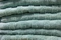 Textured green bath towels stacked close up. Royalty Free Stock Photo