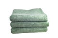 Stack of green bath towels isolated on white background Royalty Free Stock Photo