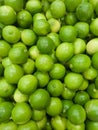 A stack of green lemons piled on a supermarket shelf Royalty Free Stock Photo