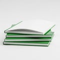Stack of green notebooks with a bookmark and a pencil on top Royalty Free Stock Photo