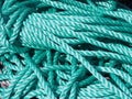 Stack of green nylon coiled and knotted marine fishing rope