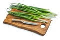 Stack Of Green Onions And Kitchen Knife On Wooden Chopping Board Isolated Royalty Free Stock Photo