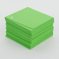 A stack of green paper sheets neatly piled on a white surface. The paper is uniformly Royalty Free Stock Photo