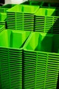 A stack of green plastic buckets. Selective focus.plastic containers.shopping mall. Vertical image Royalty Free Stock Photo