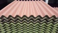 A stack of green and red ondulin sheets. Modern roofing material on sale