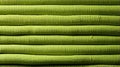 A stack of green rolled up fabric background