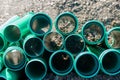 stack of green sewer pipes for laying sewerage