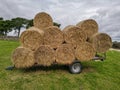 A stack of hail bails on a metal blue trailer on the farm in England Royalty Free Stock Photo