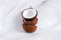 Stack of halfed coconuts on a marble background copy space