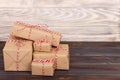 Stack of handcraft gift boxes on wooden board with a natural textured background Royalty Free Stock Photo