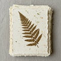 A stack of handcrafted paper features a pressed fern leaf (family: Polypodiaceae) Royalty Free Stock Photo