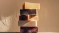 Stack of handmade soap bars on dark beige background with lavender sprigs. Wellness natural cosmetics skin body care concept