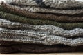 Stack of Handmade Warm Knitted Socks Scarfs Mittens From Rough Wool Yarn Brown Beige Grey. Close up. Winter Autumn Eco Fashion