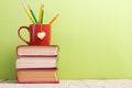 Stack of hardback books, diary on wooden deck table and green background. Back to school. Copy Space. Education Royalty Free Stock Photo