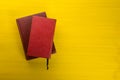 Stack of hardback books, diary on wooden deck table and yellow background. Back to school. Copy Space. Education Royalty Free Stock Photo