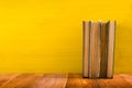 Stack of hardback books, diary on wooden deck table and yellow background. Back to school. Copy Space. Education Royalty Free Stock Photo