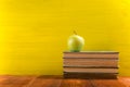 Stack of hardback books, diary on wooden deck table and yellow background. Back to school. Copy Space. Education Royalty Free Stock Photo