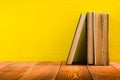 Stack of hardback books, diary on wooden deck table and yellow background. Back to school. Copy Space. Education Royalty Free Stock Photo