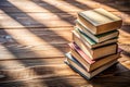 Stack of hardcover books arranged haphazardly viewed from a high angle on a wooden desk or table with copyspace and shadow behind Royalty Free Stock Photo