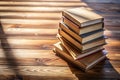 Stack of Hardcover Books Arranged Haphazardly Viewed from a High Angle on a Wooden Desk or Table with Copyspace and Shadow Behind Royalty Free Stock Photo
