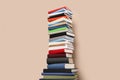 Stack of hardcover books on beige background
