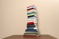 Stack of hardcover books on beige background