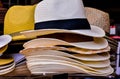 A stack of hats, including a straw hat, a white hat, and a yellow hat Royalty Free Stock Photo
