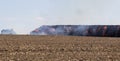 Stack hay in fire on field with blue sky Royalty Free Stock Photo