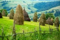 Stack of hay on a mountain meadow on a hillside. Royalty Free Stock Photo