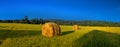 Gorgeous landscape of a stack of hay in rural areas during fall season with warmest colors and attractive composition. Royalty Free Stock Photo