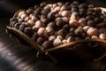 Stack of Hazelnuts in wooden bowl. dim light